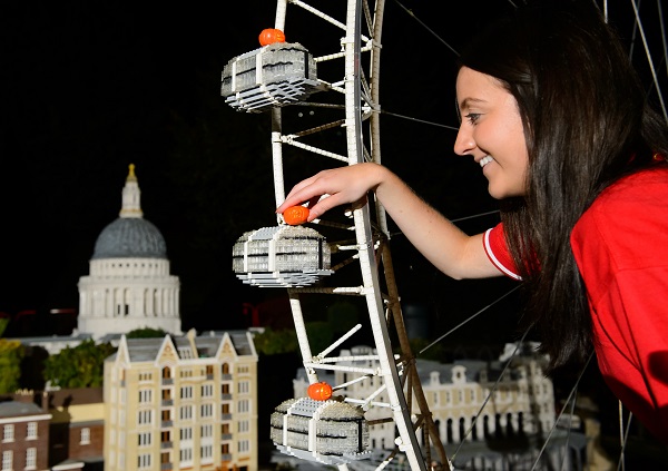 Model maker Melissa Maughan places a miniature carved pumpkin onto the London Eye at the LEGOLAND Windsor Resort.